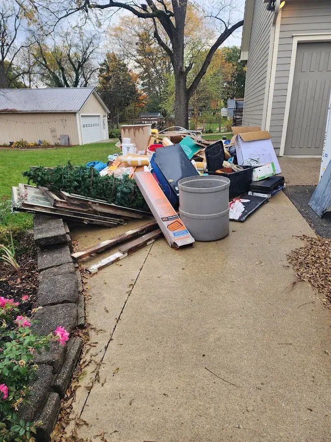Dumpster being loaded with debris for Roofing Dumpster Rental in Merrimac